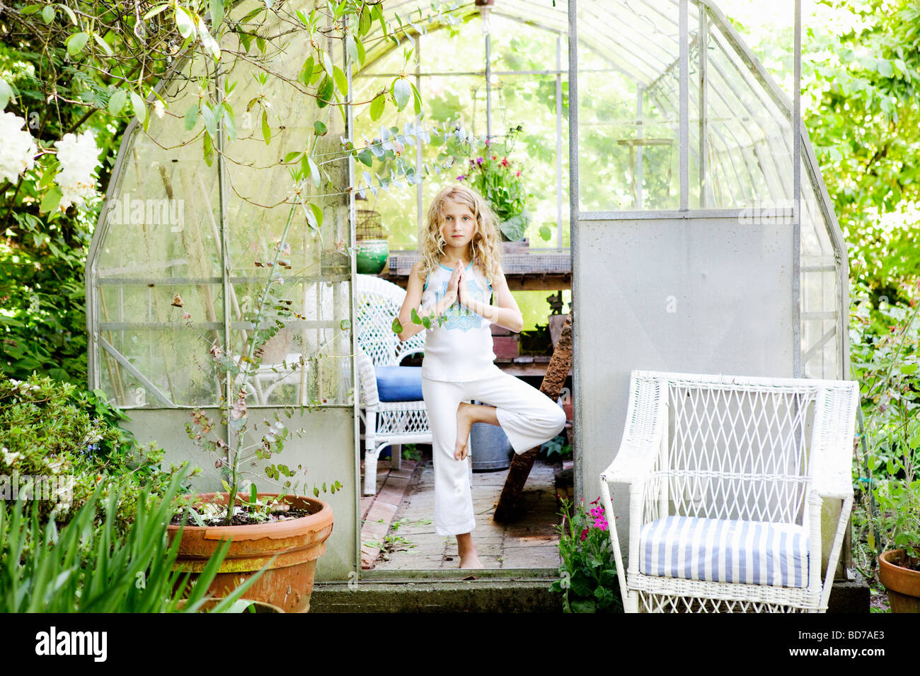 Girl practicing yoga in greenhouse Stock Photo Alamy
