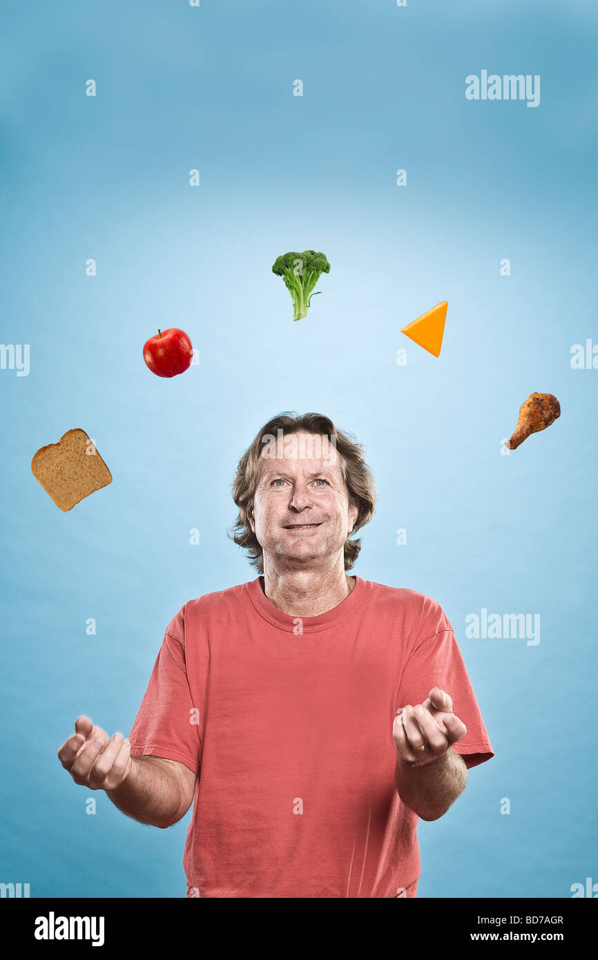 Man juggling different foods Stock Photo