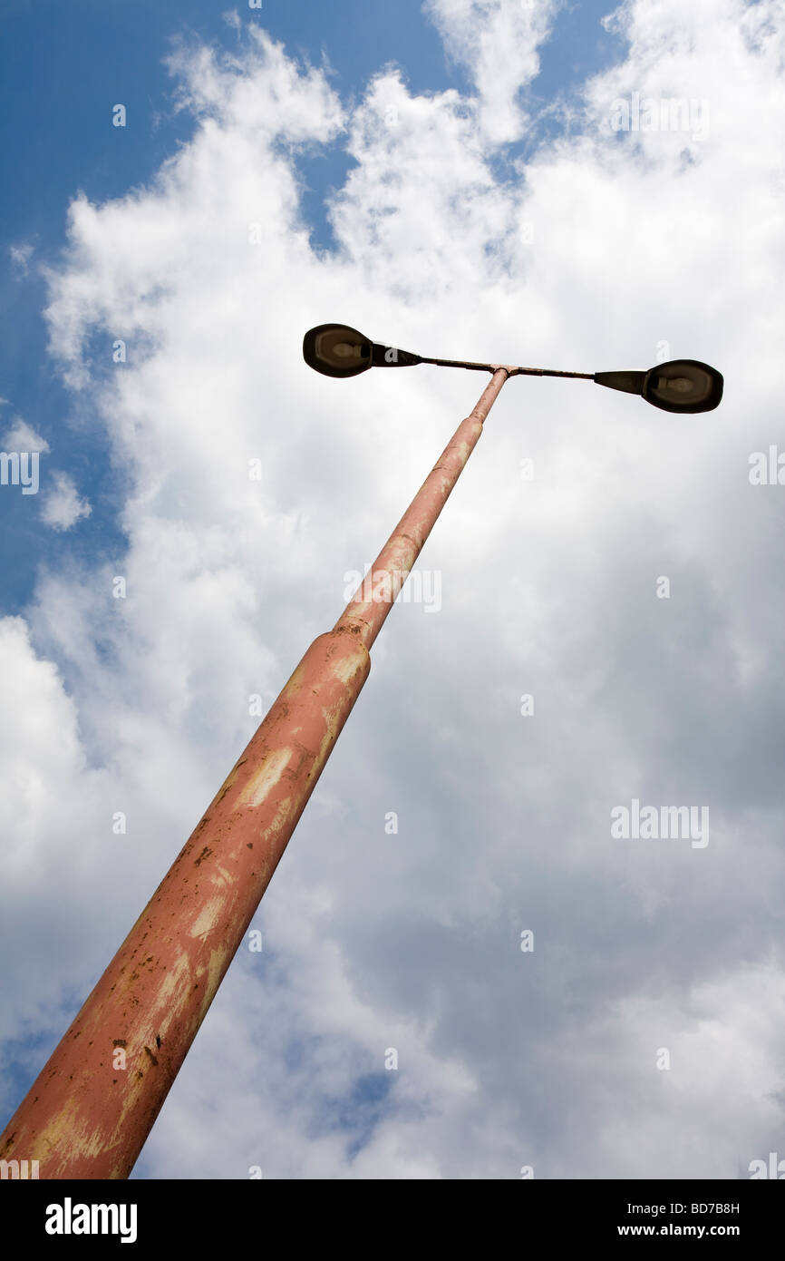 weathered old streetlamps against cloudy sky Stock Photo