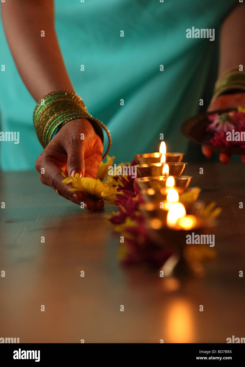 Cropped images of Indian woman lighting up the oil lamp Stock Photo Alamy