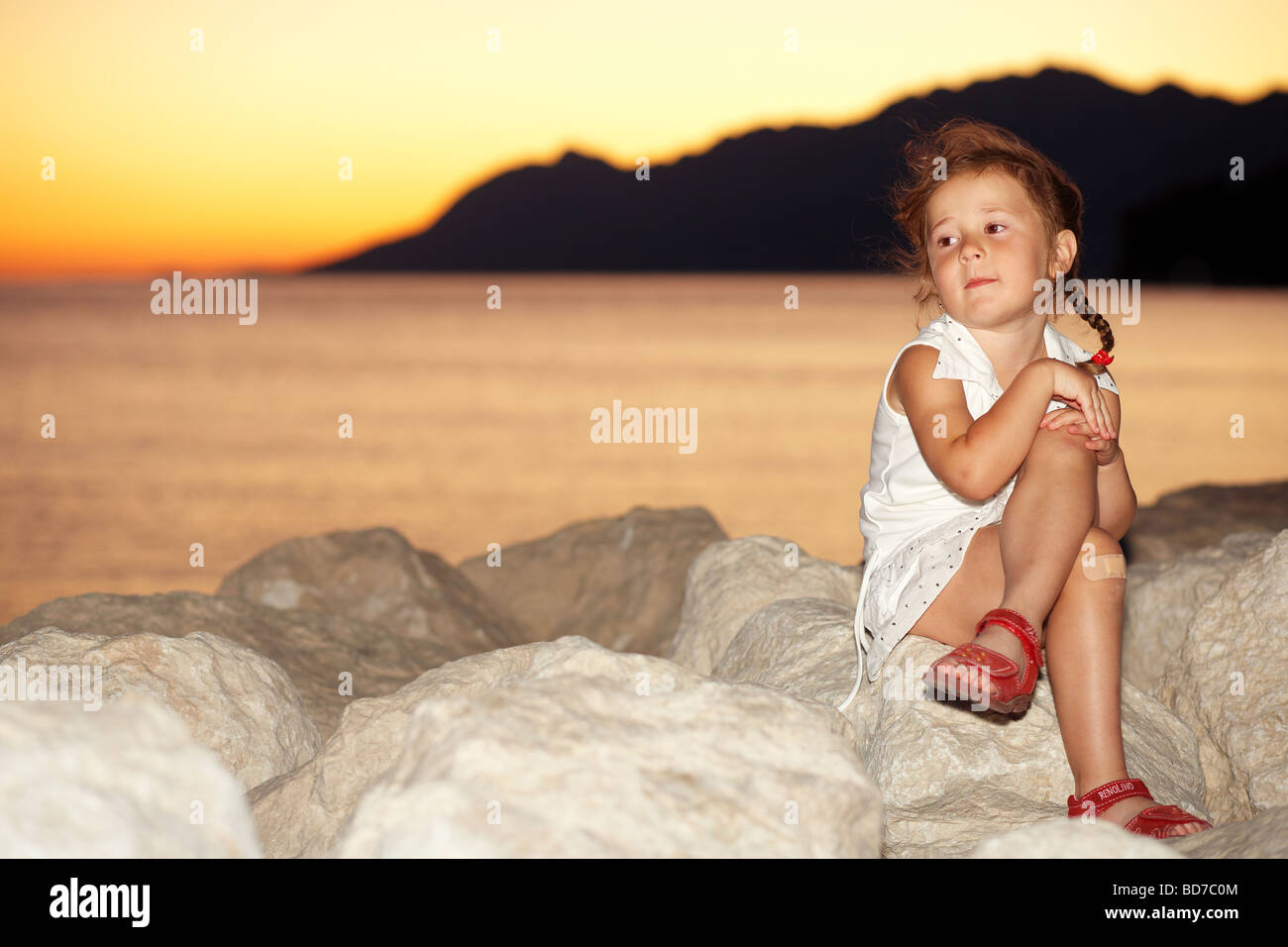 Young girl by the sunset Stock Photo - Alamy