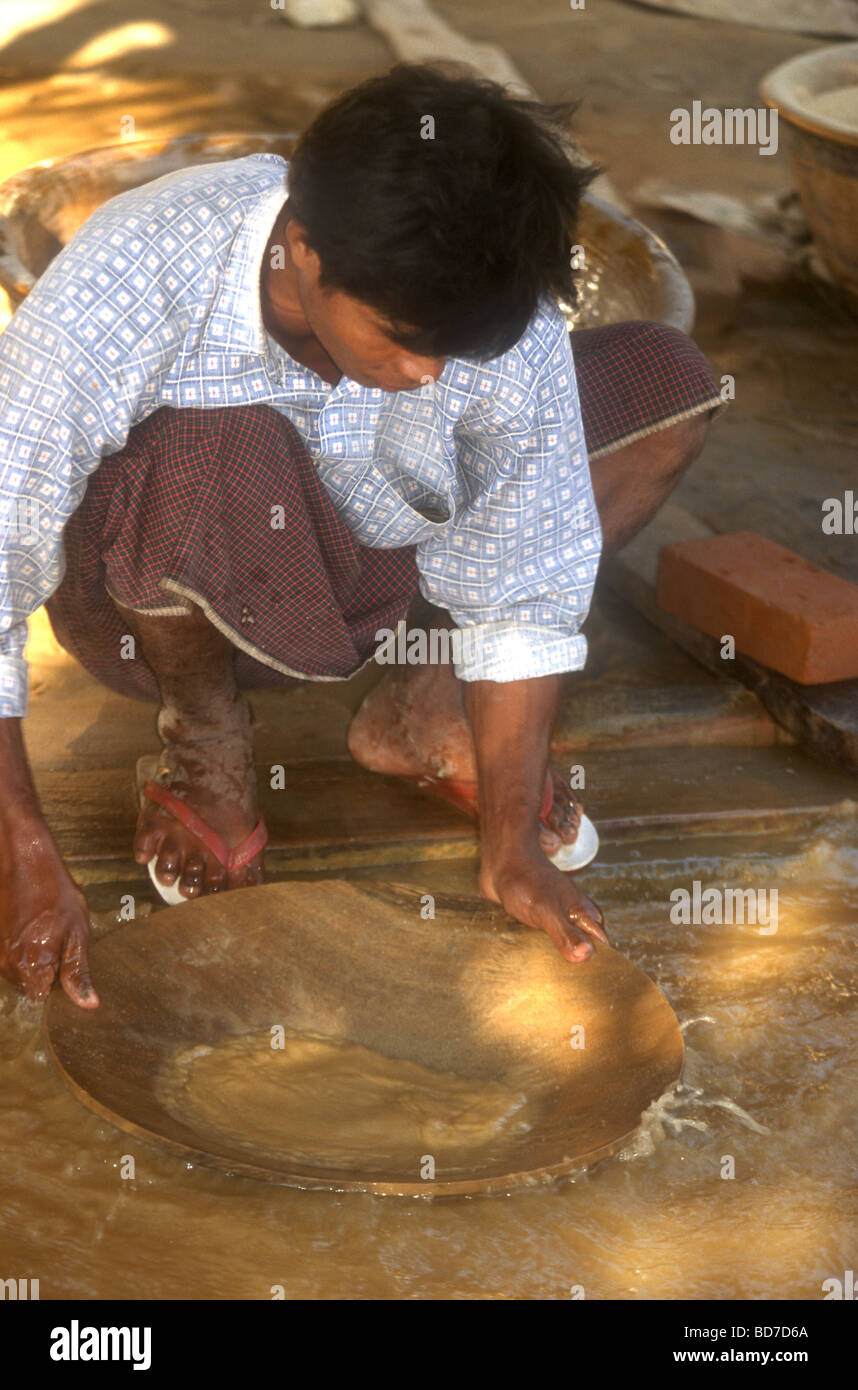 Young Burmese man pans for gold near Mamyo in Myanmar Stock Photo