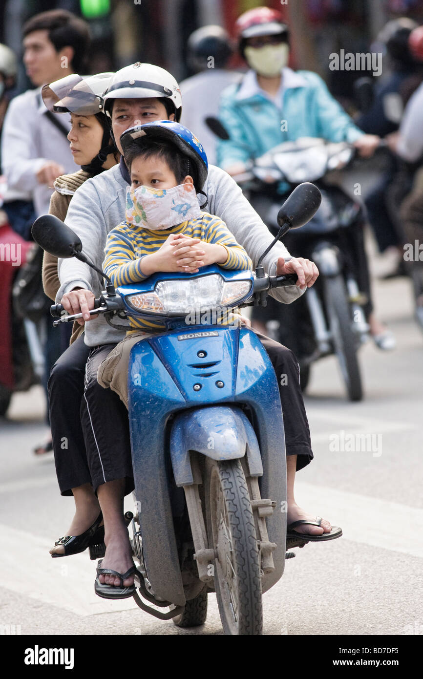 People riding scooters/mopeds in Vietnam in Hanoi Stock Photo