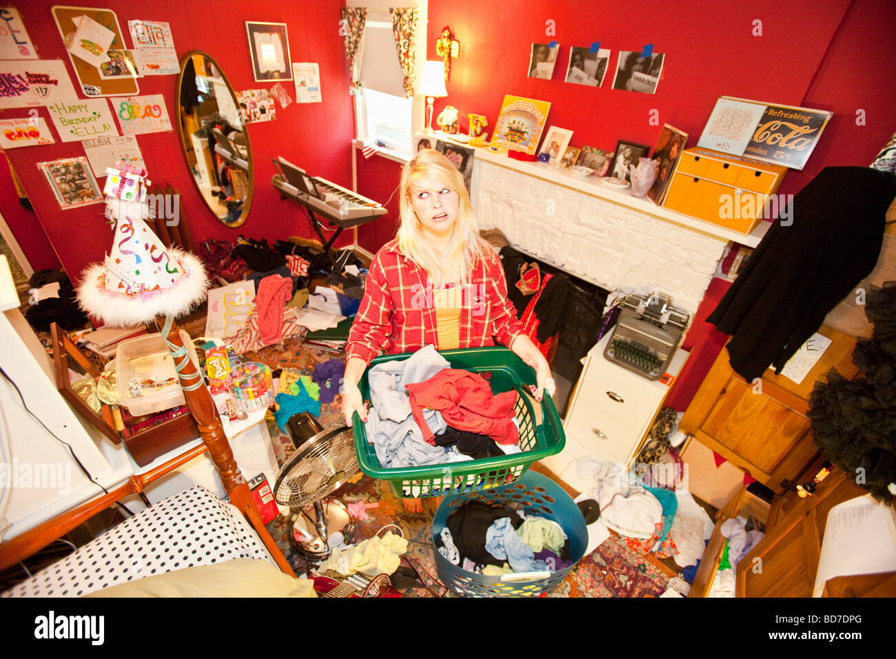 Teen girl in messy room Stock Photo