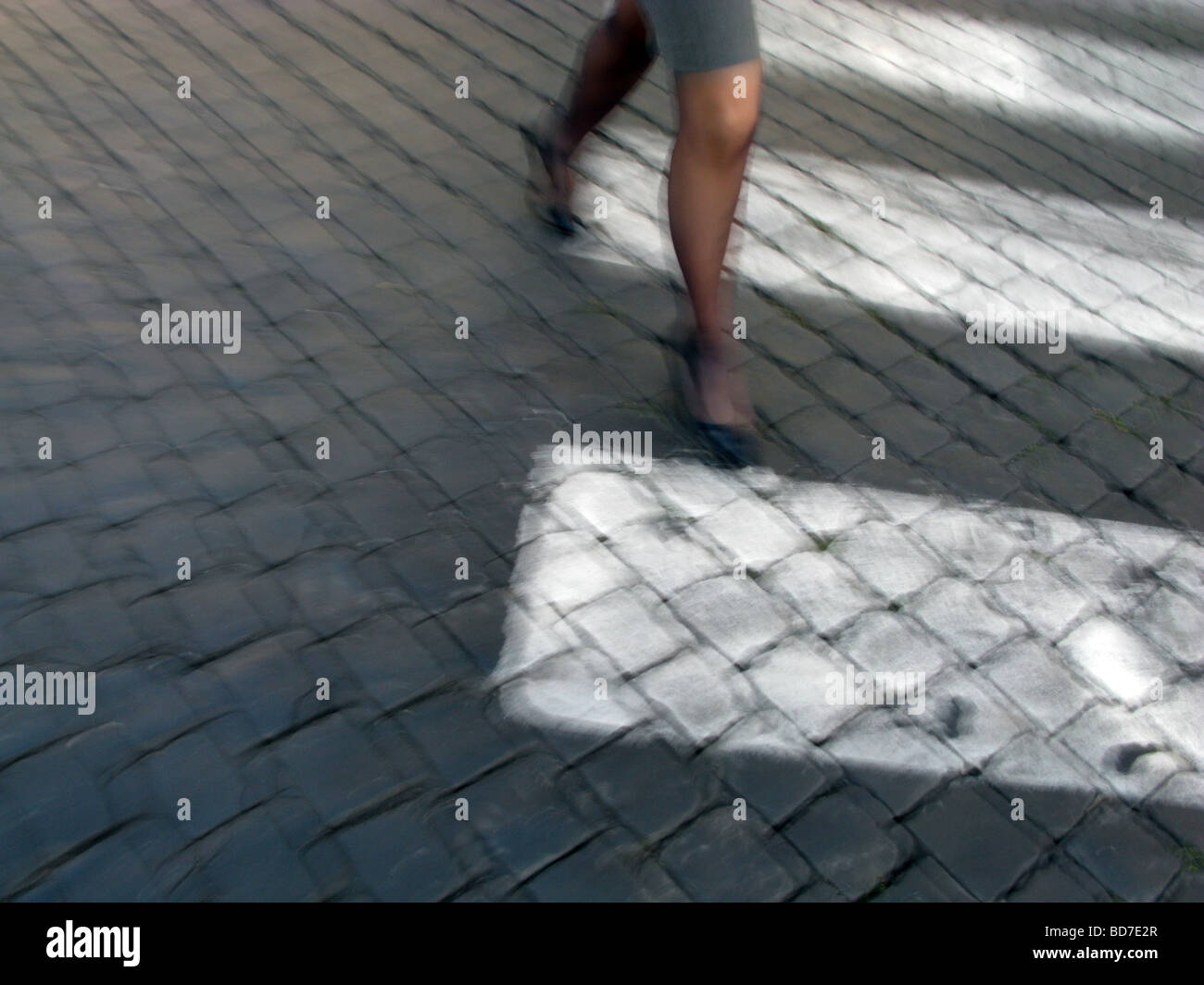 one woman walking crossing road in city town Stock Photo - Alamy