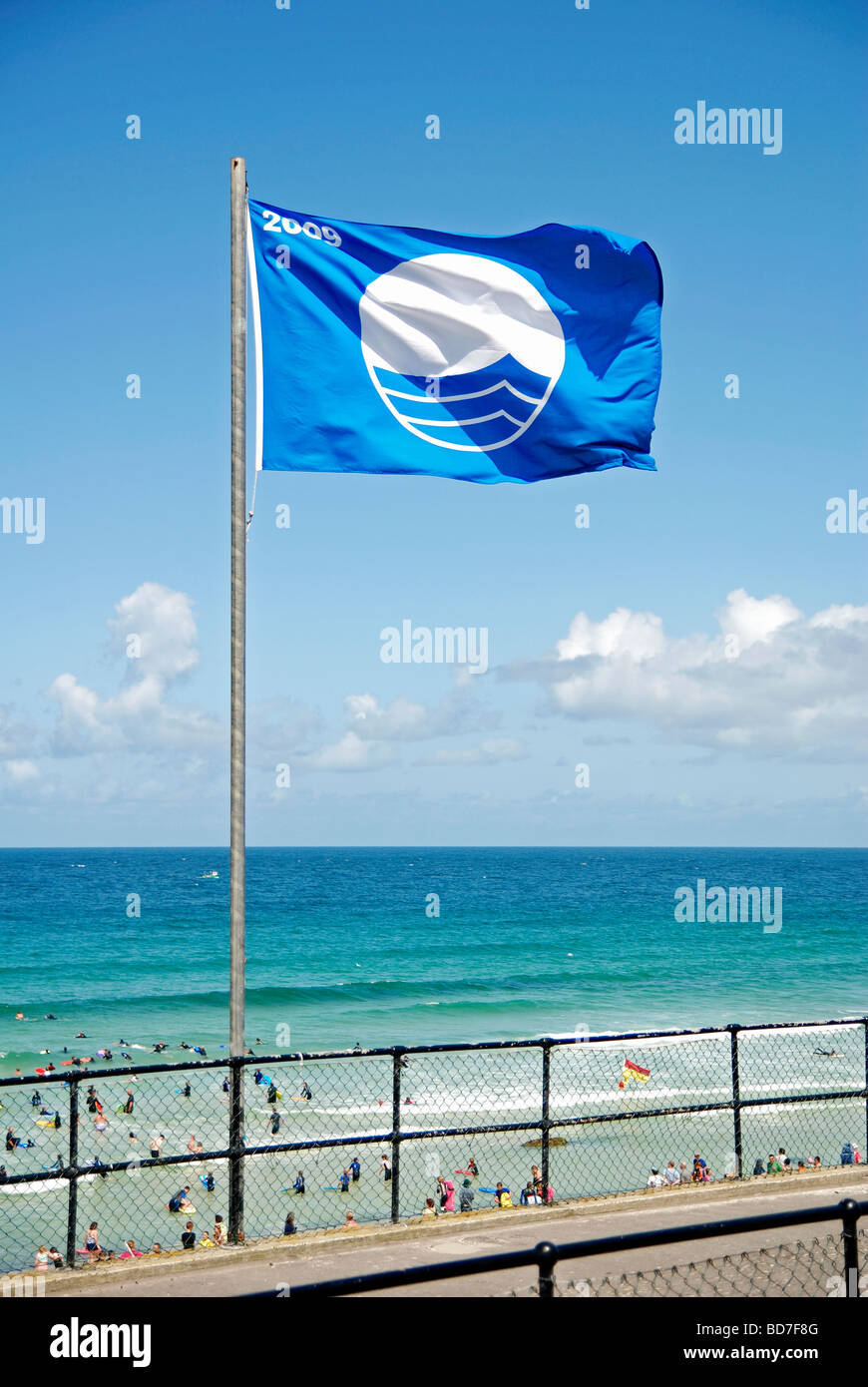 the blue flag for beach and water cleanliness flying over porthmeor beach in st.ives,cornwall,uk Stock Photo