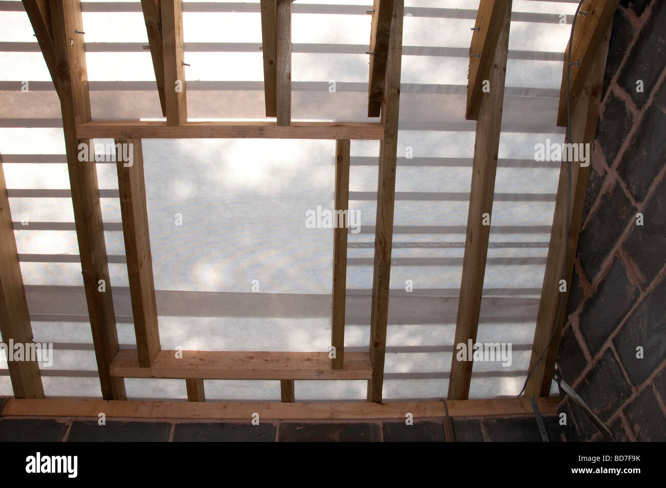 New roof rafters with felt on before tiles are fixed looking from inside Stock Photo