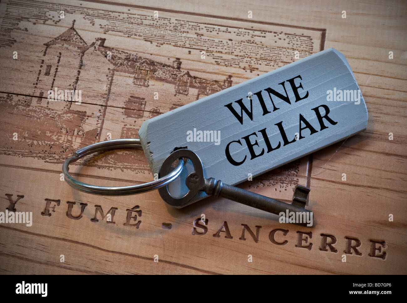 Key to wine cellar on french wooden wine box lid Stock Photo