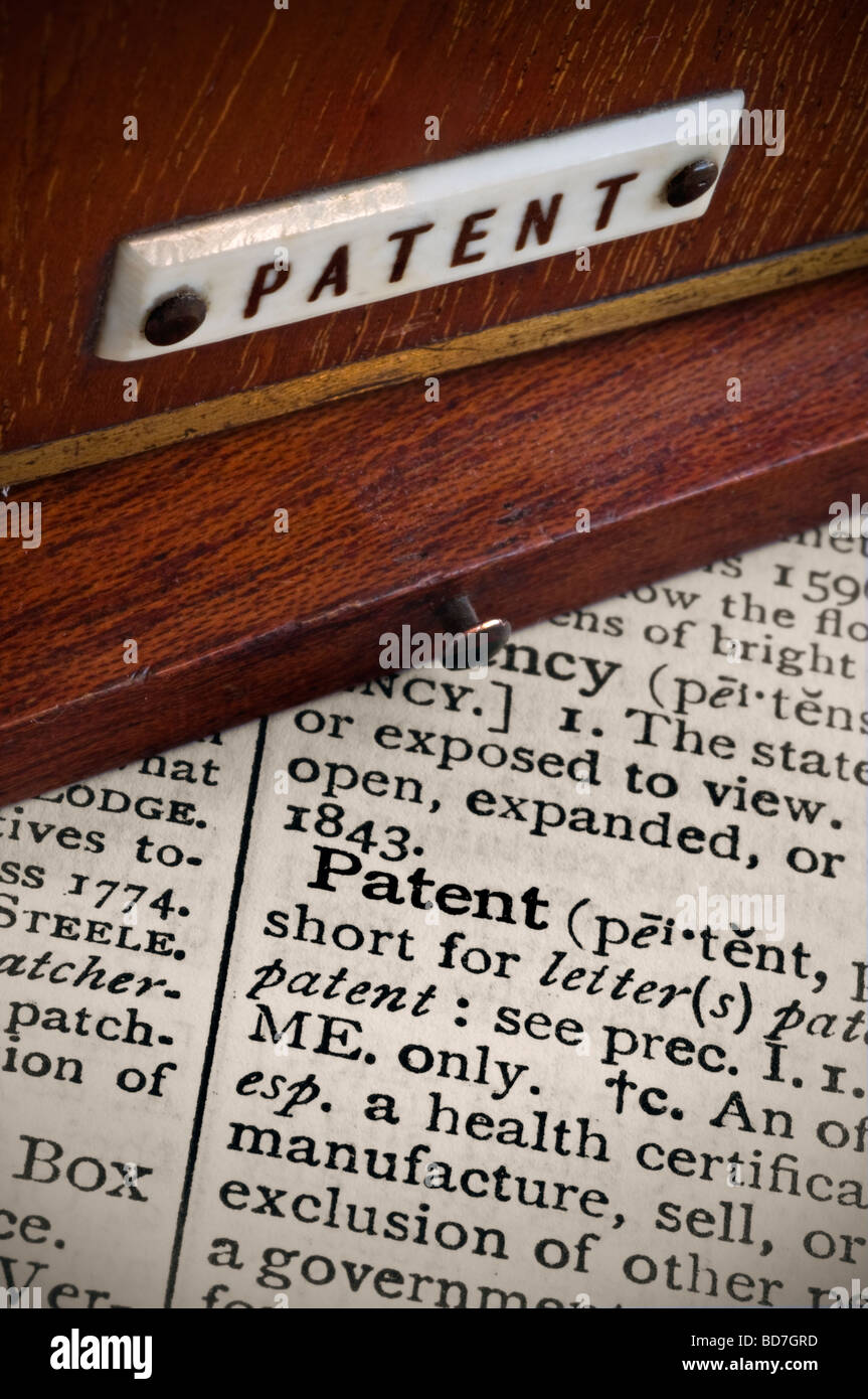 Old vintage patent label on mahogany casing with legal dictionary description in close up Stock Photo