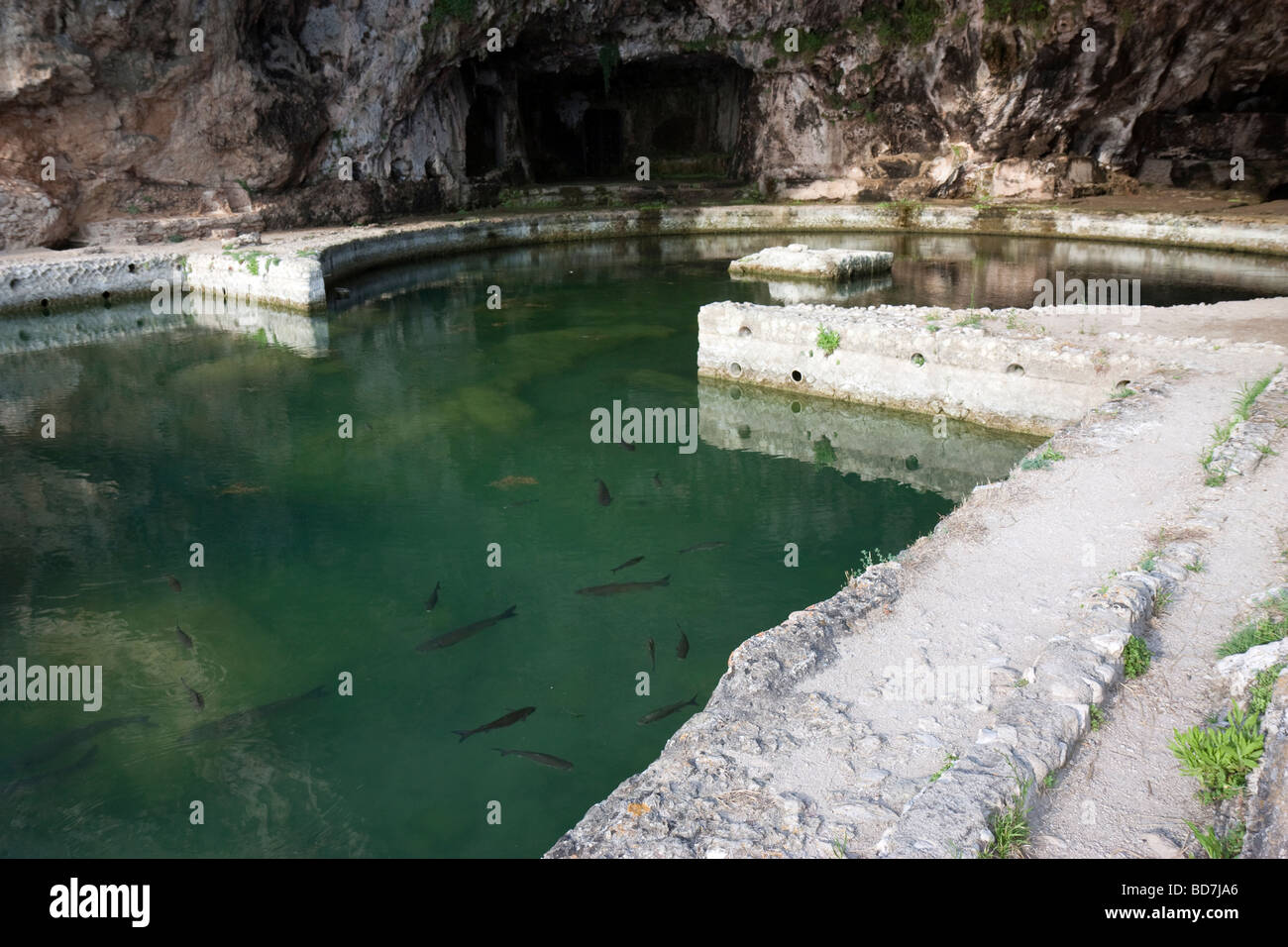 The interior of the Grotto of Tiberius at Sperlonga, showing the ancient fish ponds still teeming with fish to this day. Stock Photo