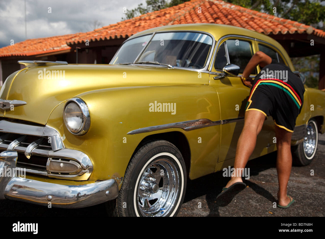 man cleaning old car in Viñales Stock Photo Alamy