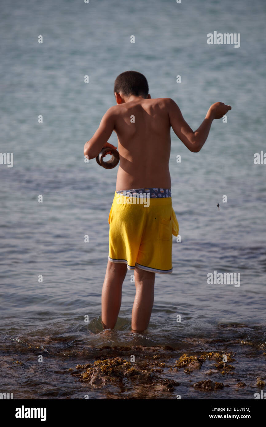young boy fishing in the sea Stock Photo