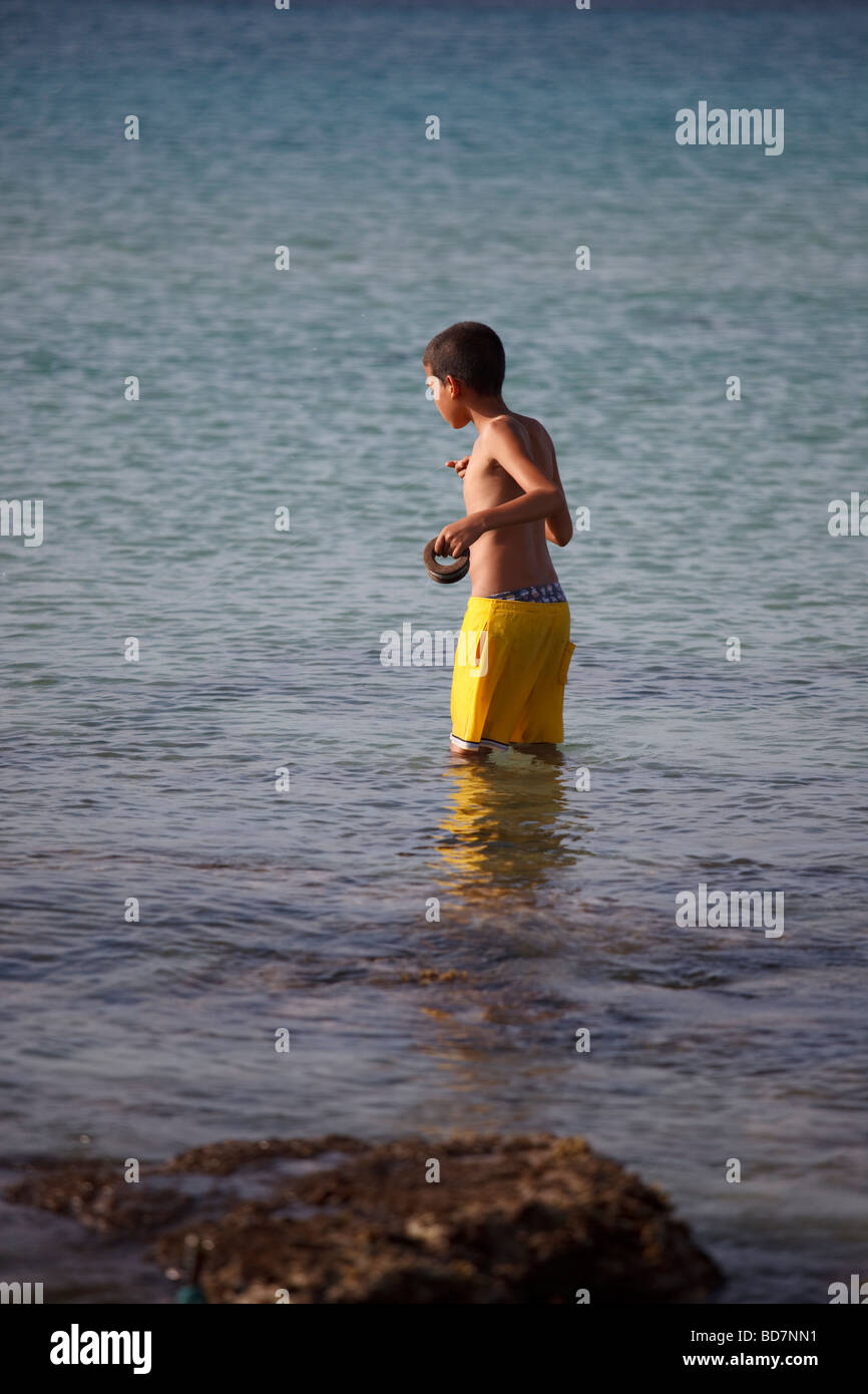 young boy fishing in the sea Stock Photo