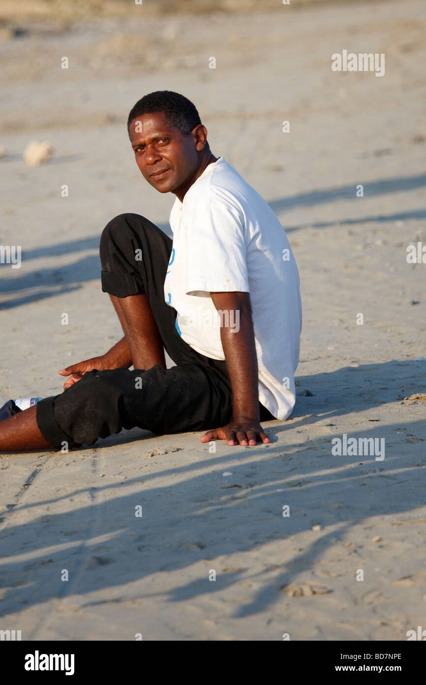 man sitting on the beach Stock Photo