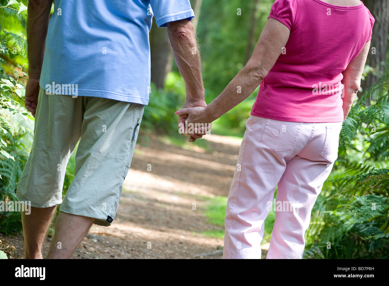 Pensioners walking holding hands hi-res stock photography and images ...