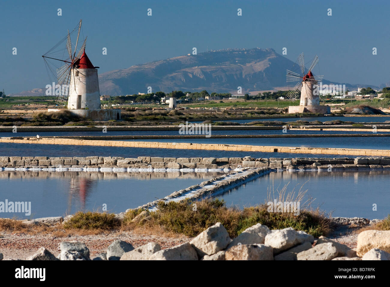 Windmills at the salt pans (saline) of Marsala, Sicily. Stock Photo