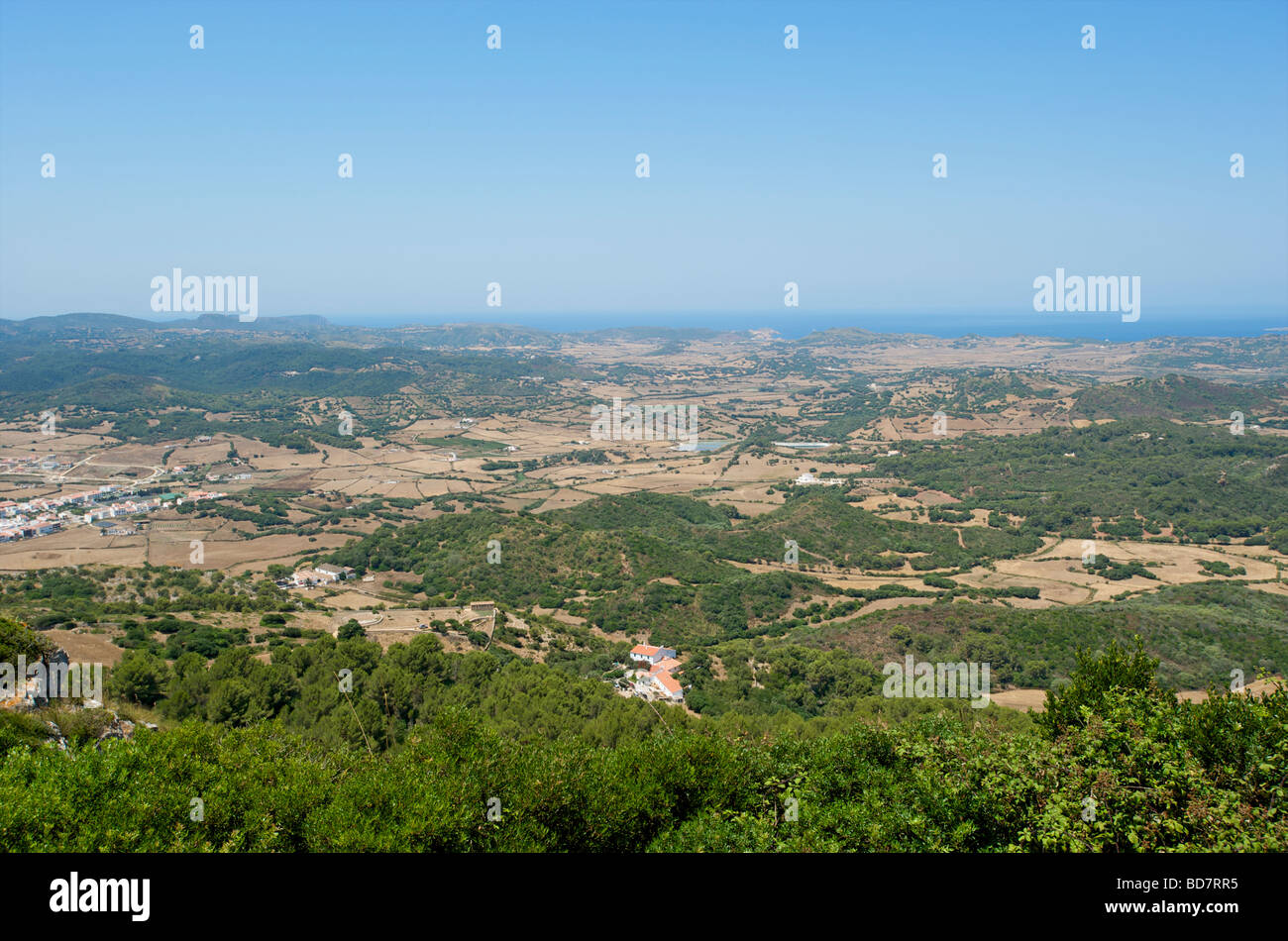 The view north from Monte Torro the highest point on Menorca showing the lighthouse at Cap de Cavalleria in the distance Stock Photo