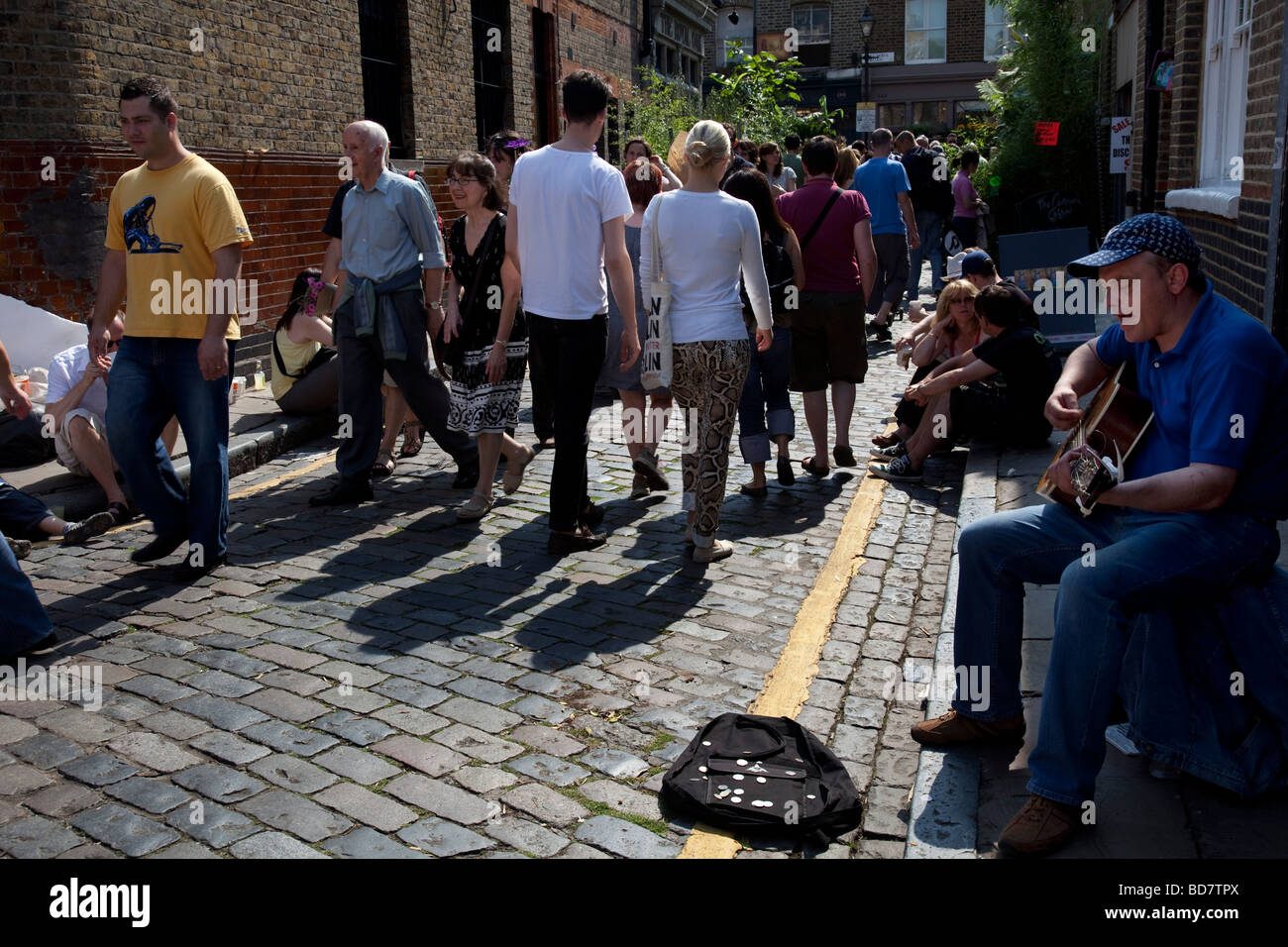 People gather at Columbia Road Flower Market in the East End of London. This market is as much social as it is about buying. Stock Photo