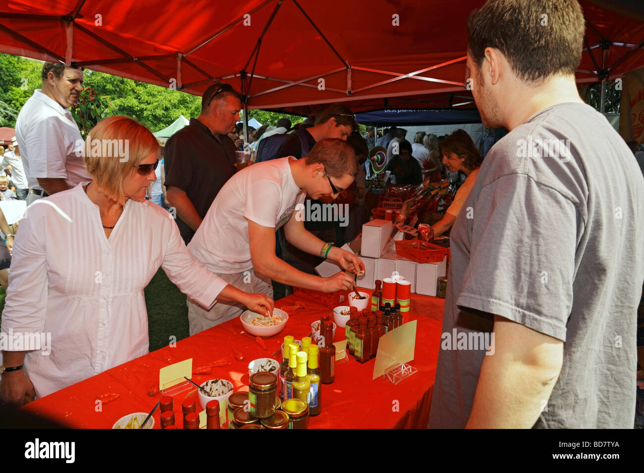 People trying various chilli sauces West Dean Chilli Fiesta West Sussex England UK Stock Photo