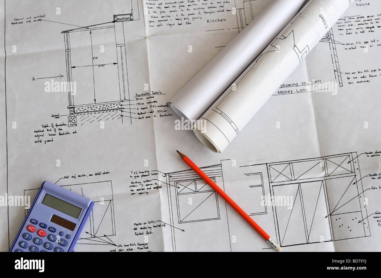 Home extension building plans with calculator and pencil Stock Photo