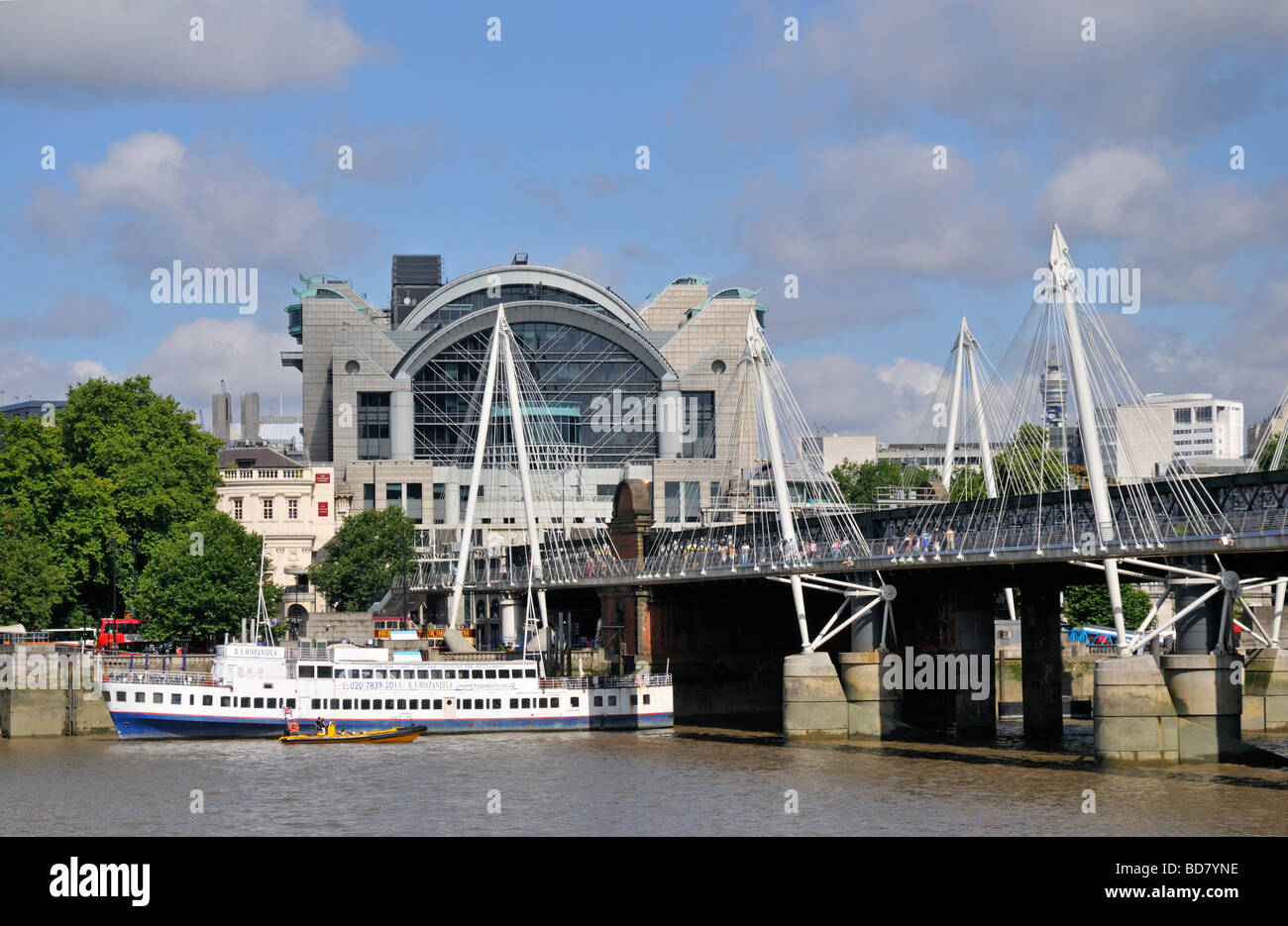 Charing Cross railway station and Hungerford Suspension Footbridge, Thames embankment, London, United Kingdom Stock Photo