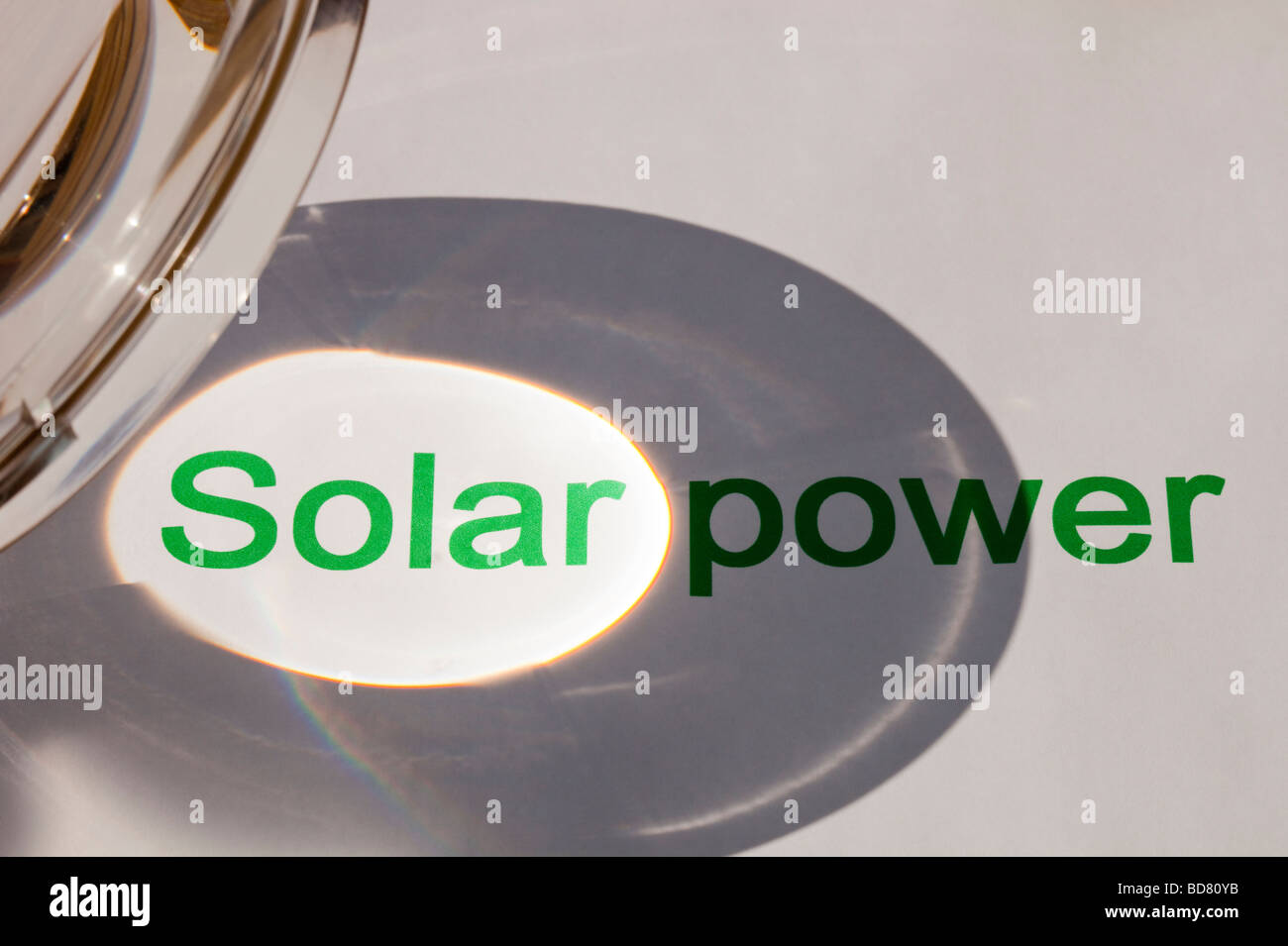 Solar power concentrating the suns power through a magnfying glass Stock Photo