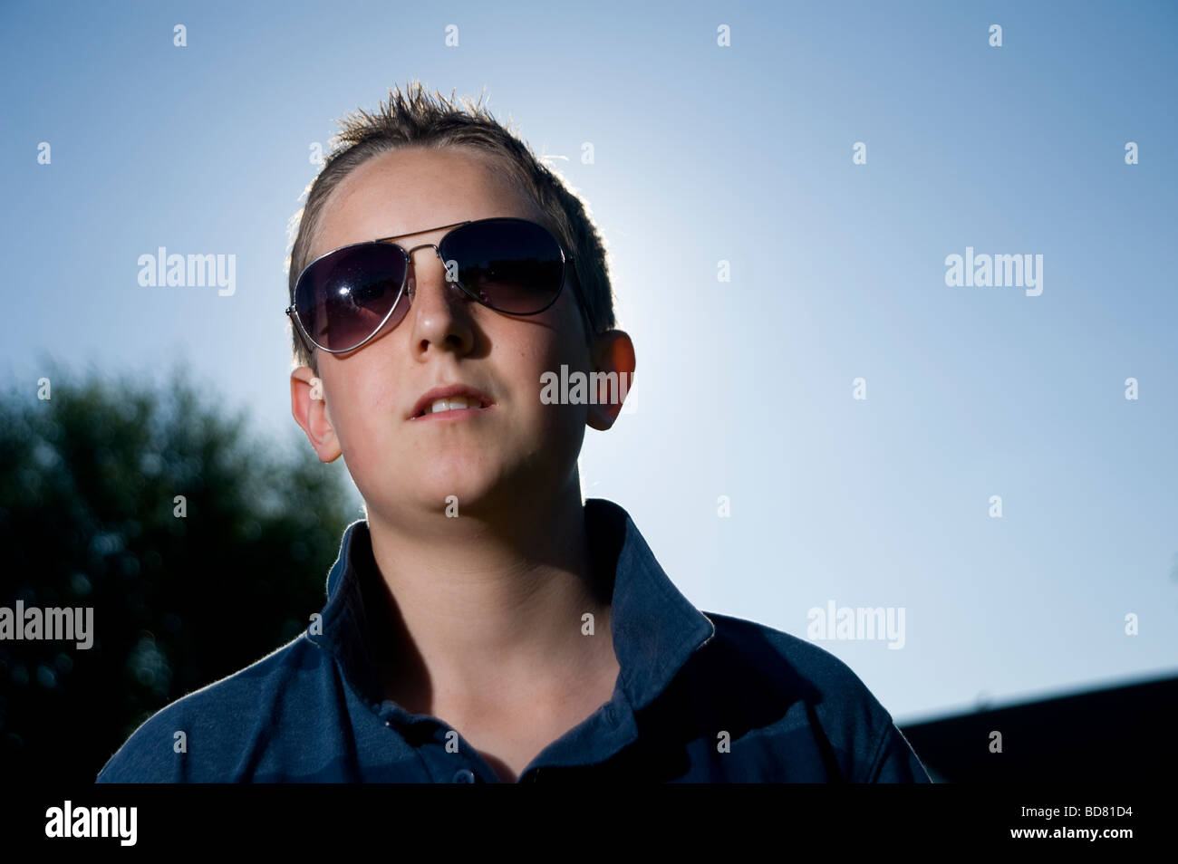 Portrait of a young teenage boy wearing sunglasses Stock Photo Alamy