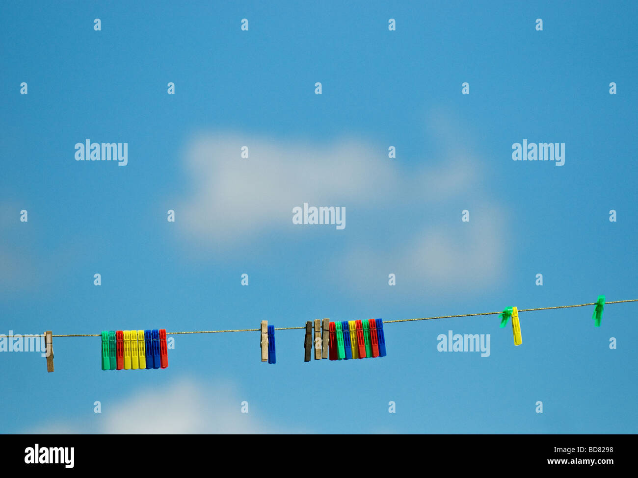 Colourful plastic clothes pegs on a washing line.  Photo by Gordon Scammell Stock Photo