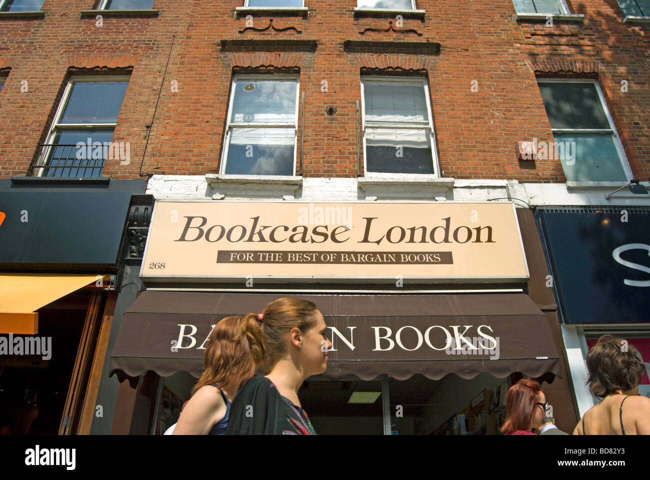 young women pass a called bookcase london, in chiswick, west