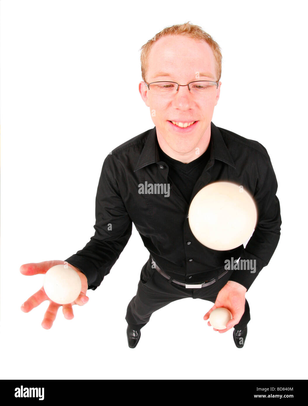 young man juggling with three balls Stock Photo