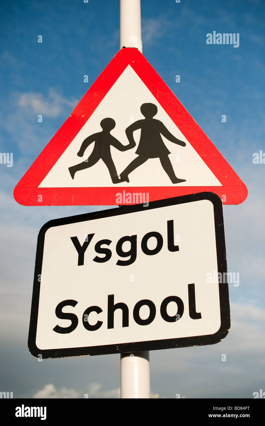 Bilingual sign school ysgol welsh English warning triangle sign Stock Photo