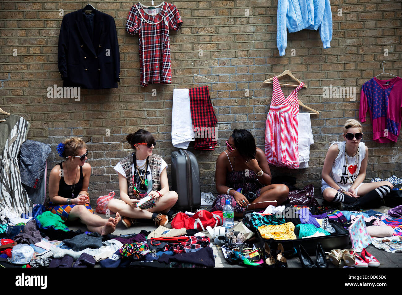 Sellers at Brick Lane for the Sunday Market. Many people come to sell their cast off clothes and belongings to raise some cash. Stock Photo