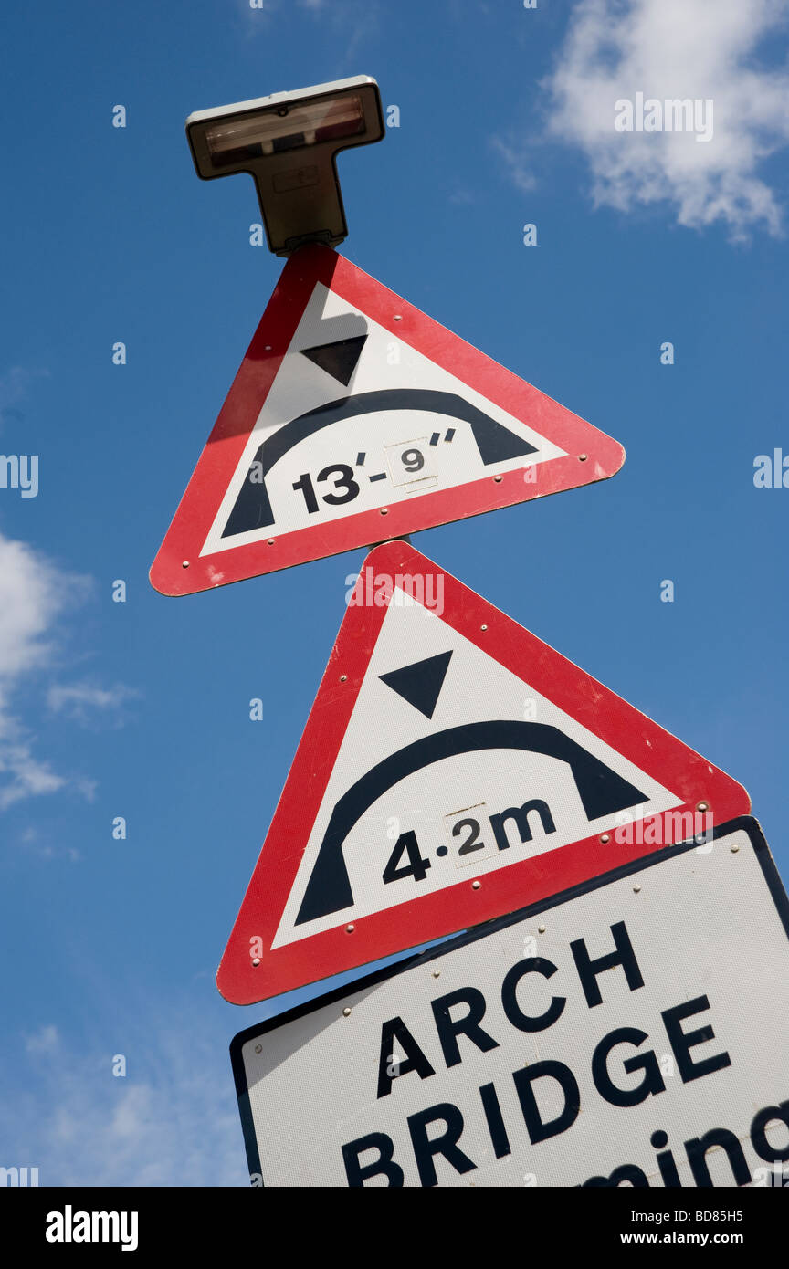 Two red triangle low bridge road warning signs in England Stock Photo