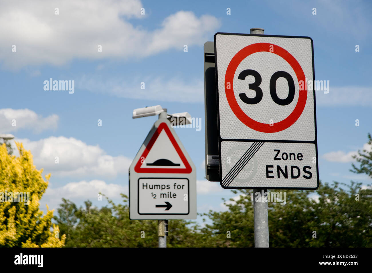Multiple road signs showing traffic is entering a 30 mph area and traffic calming measures Stock Photo