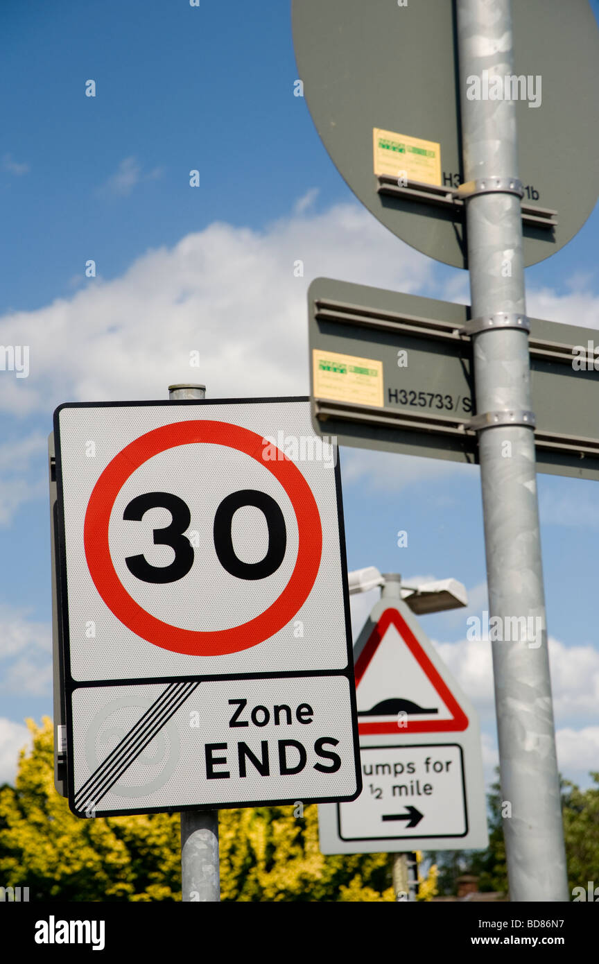 Multiple road signs showing traffic is entering a 30 mph area and traffic calming measures Stock Photo