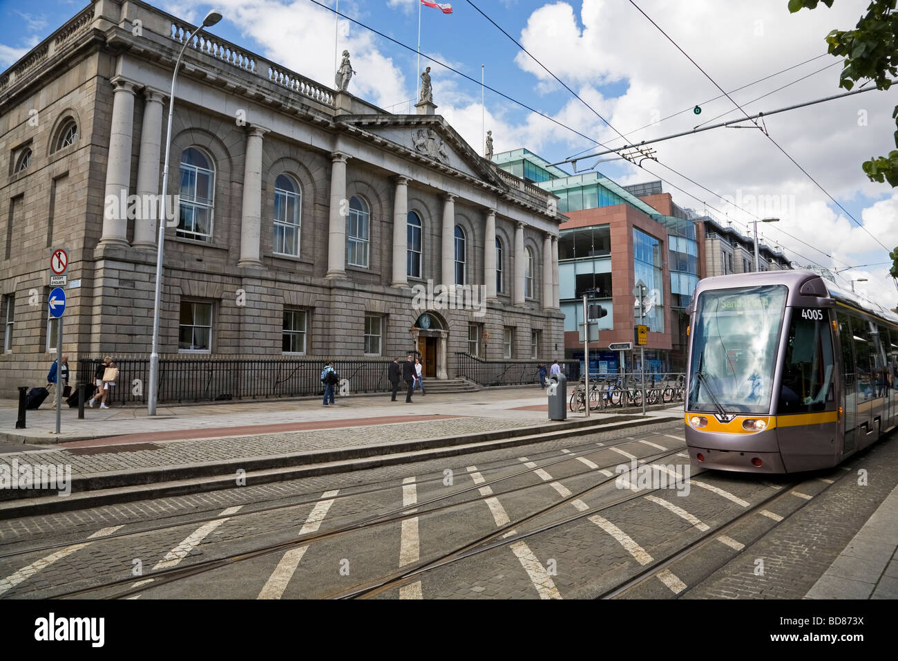 Modern LUAS Tram in front of Iveagh House, Designed by Robert Cassels, now Dept of Foreign Affairs, Built 1730, Dublin City, Ireland Stock Photo