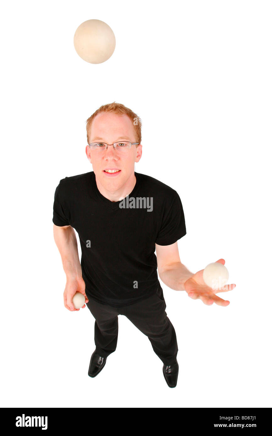Young man juggling with three balls hires stock photography and images