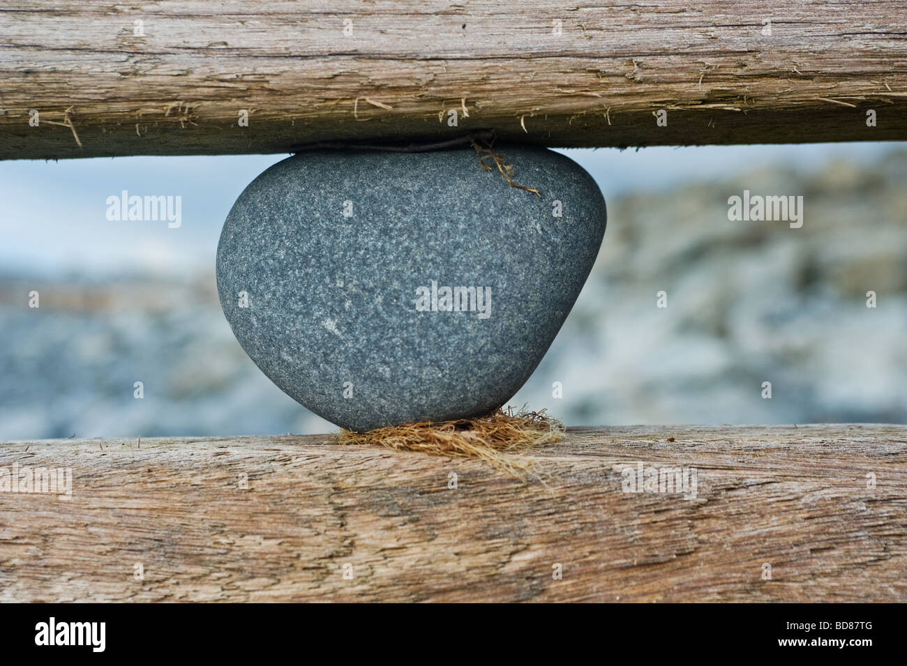 a stone jams in the sea defences on the South Beach of Aberaeron West Wales the photograph by Andrew Chittock as eight abstracts Stock Photo