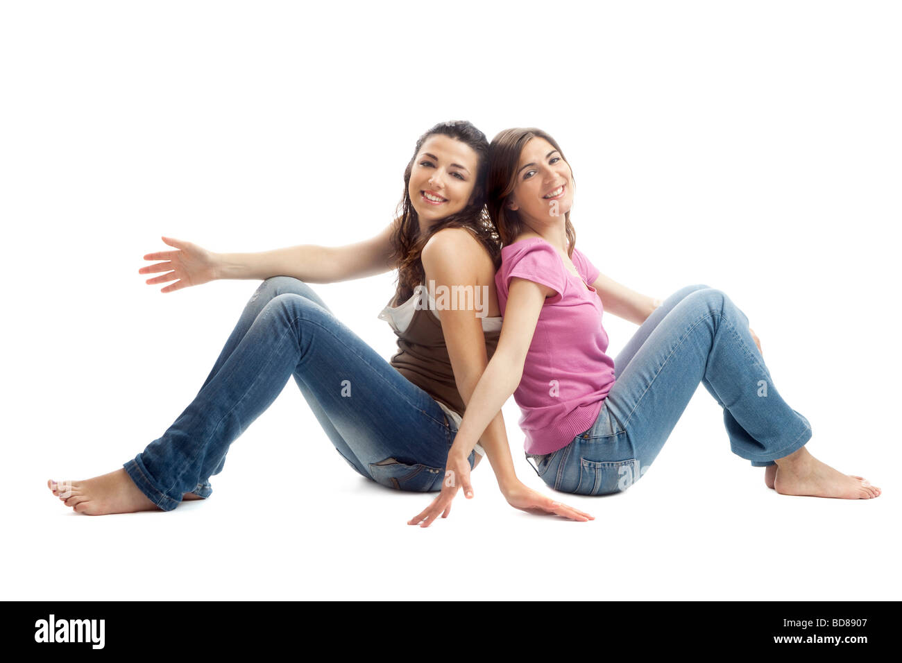 two beautiful young women sitting on floor Stock Photo - Alamy