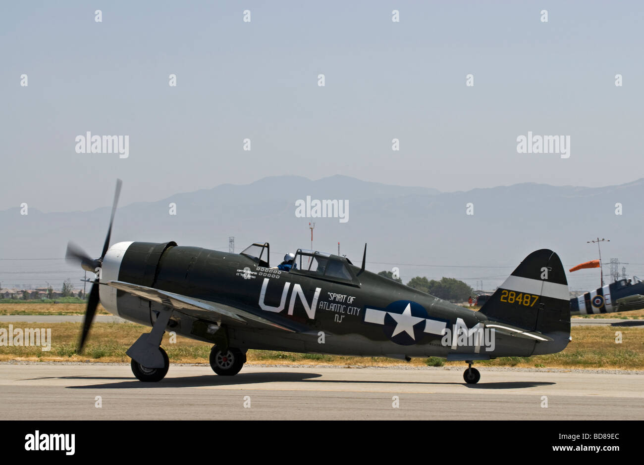 A Republic P-47G Thunderbolt taxis on the runway after flying at an air show. Stock Photo