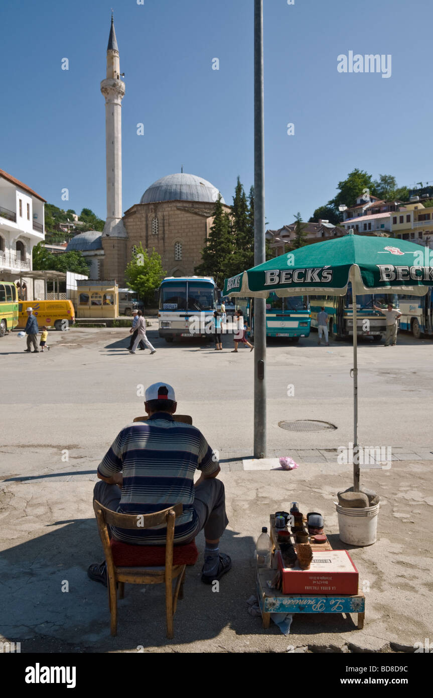 A shoe shine stall in the centre of Berat looking towards the Leaden Mosque in the old town of Berat in central Albania Stock Photo