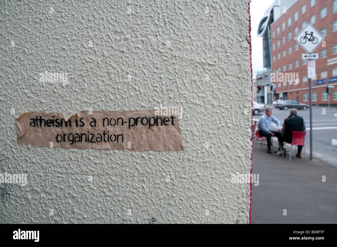 A label promoting atheism stuck to a wall in Melbourne Australia Stock Photo