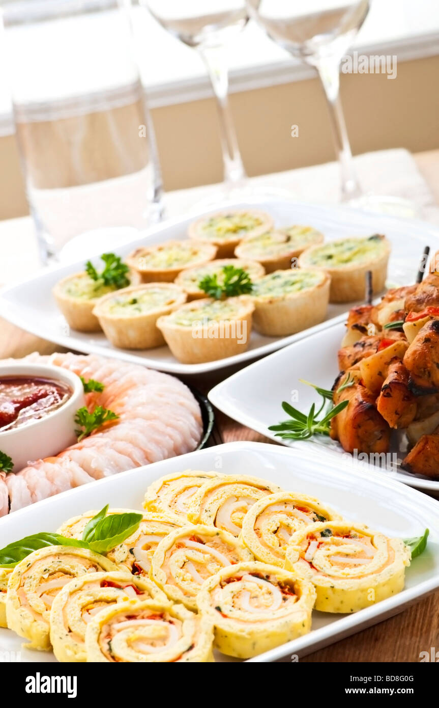Many dishes of bite size appetizers and party food Stock Photo
