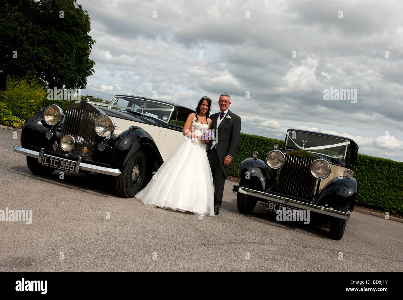 Bride with her father and two old Rolls Royce cars Stock Photo