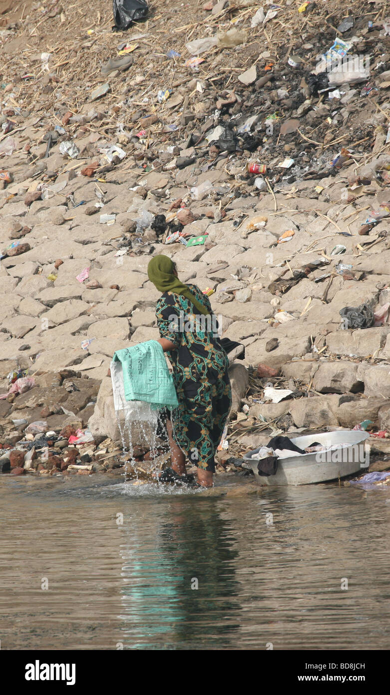 Woman washing clothes on the bank of the River Nile Stock Photo