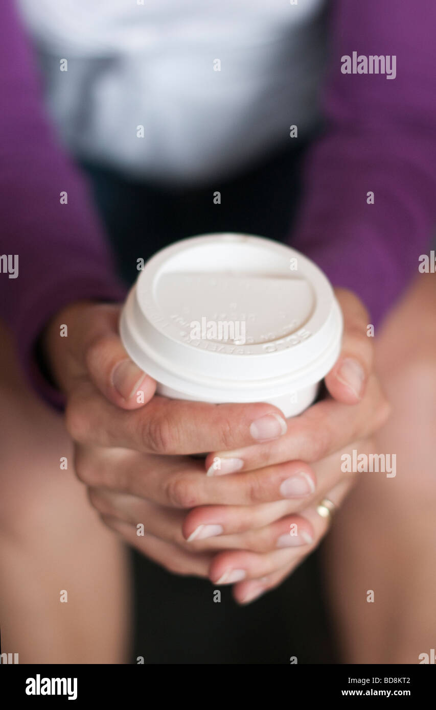 Person holding coffee in a take away paper cup close up Stock Photo