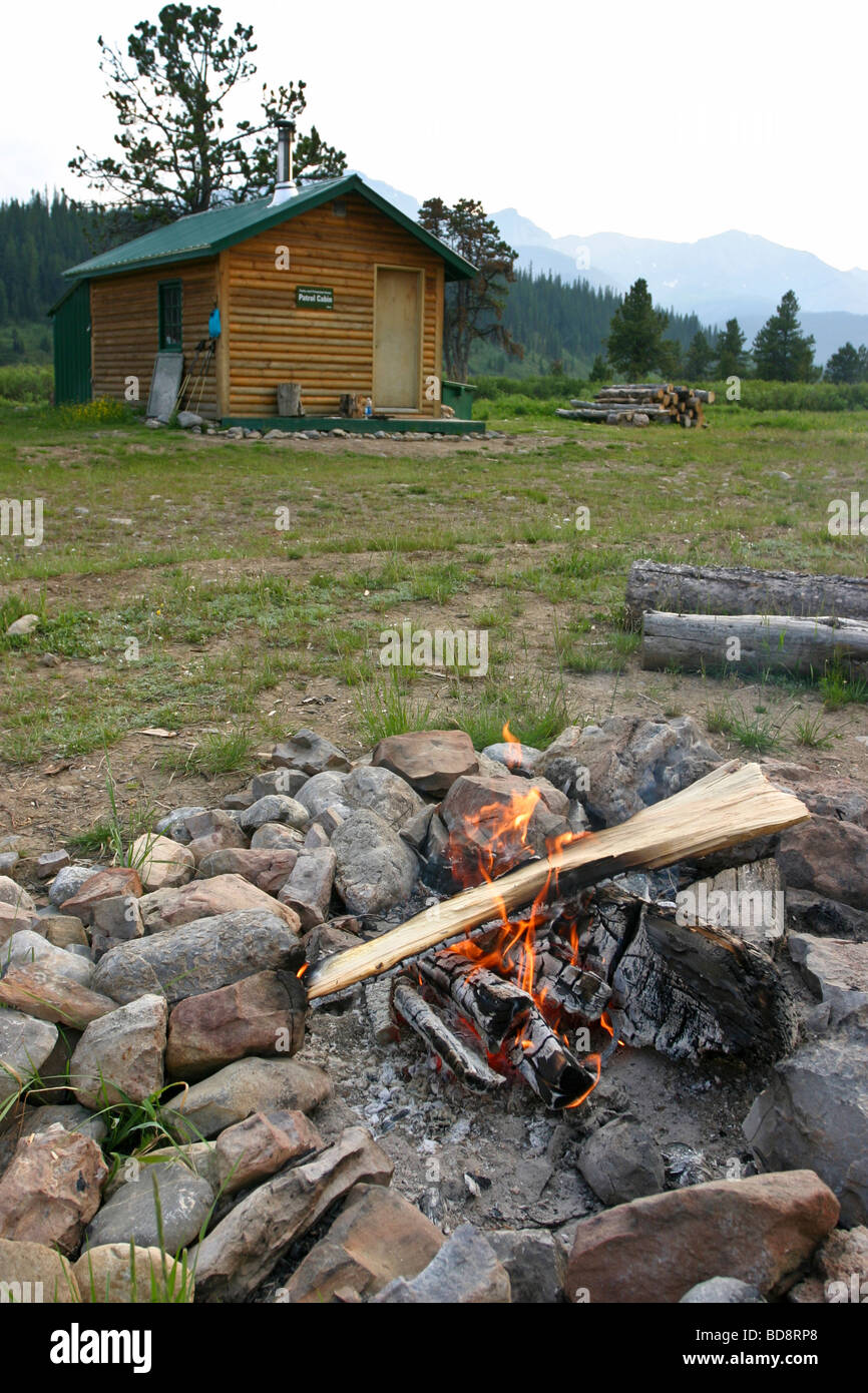 Log cabin and campfire in the Willmore Wilderness Park Canada Stock Photo