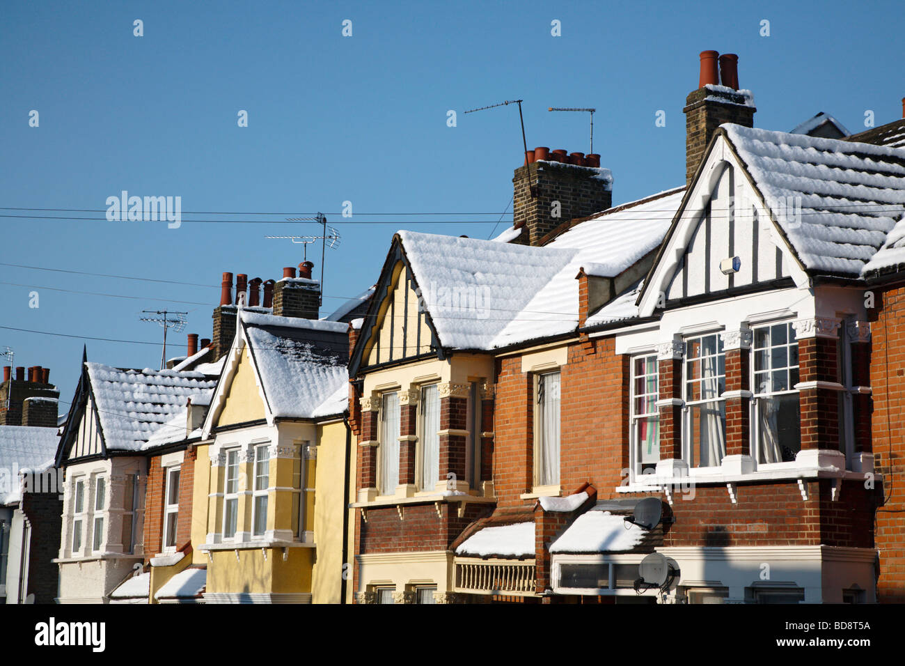 London Edwardian terraced house roofs under snow Stock Photo