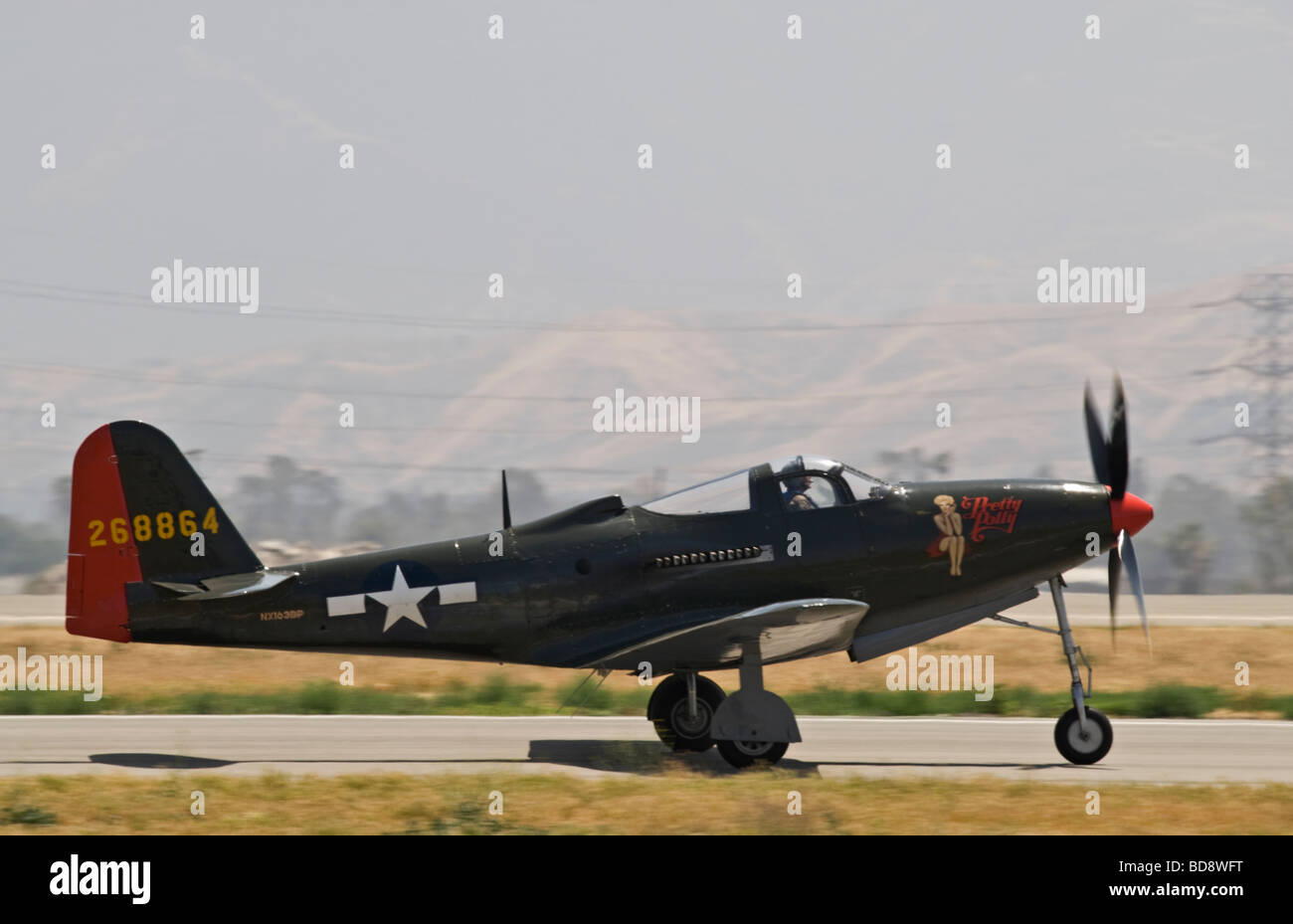 A P-63 Kingcobra taxis on the runway after flying at an air show. Stock Photo