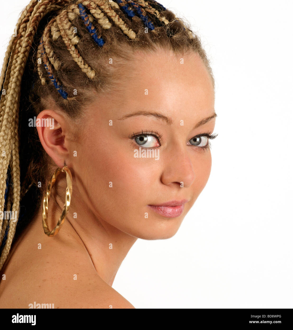 young woman with cat like eyes and braids in her hair Stock Photo